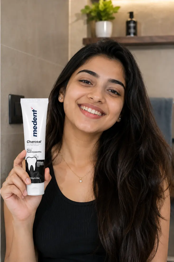 Smiling customer holding Medent Charcoal
